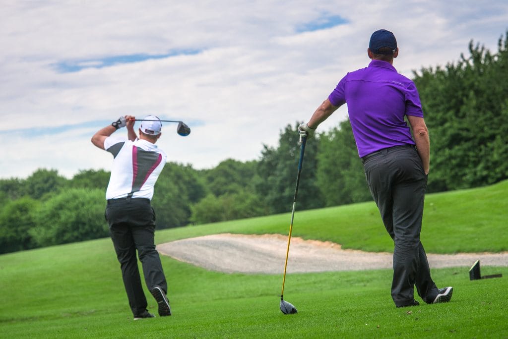 Two golfers playing on the 18 hole golf course in Telford at The Shropshire Golf Club, enjoying a sunny golf day in Telford