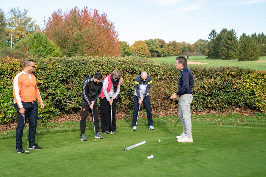 Group golf lesson on the putting green at The Shropshire Golf Club in Telford, part of beginner golf lessons and group golf coaching in Telford