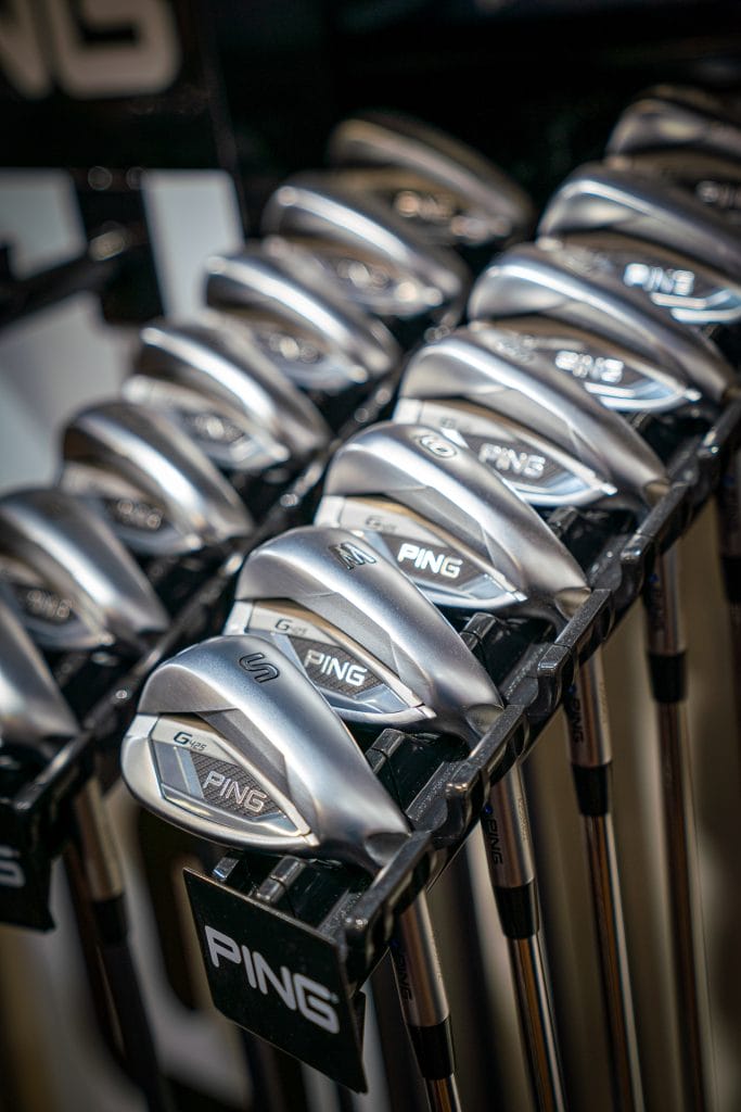 Rows of golf irons displayed in the pro golf shop at The Shropshire Golf Club in Telford, featuring golf equipment and golf club fitting in Telford