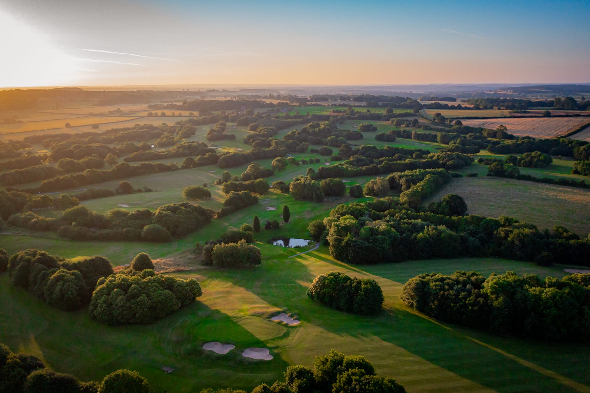 Aerial view of The Shropshire’s 18 hole golf course in Telford, showcasing scenic fairways, water features, and bunkers at a top golf club in Telford