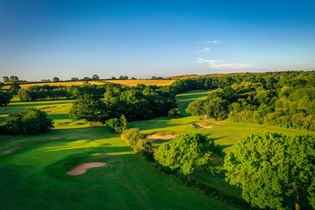 Golf hole with sand bunkers and mature trees on the 18 hole golf course in Shropshire at The Shropshire Golf Club