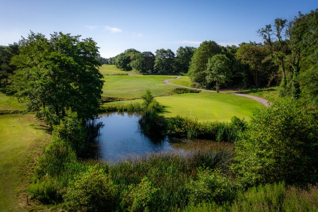 Scenic golf hole with water hazard at The Shropshire Golf Club’s 18 hole golf course in Telford