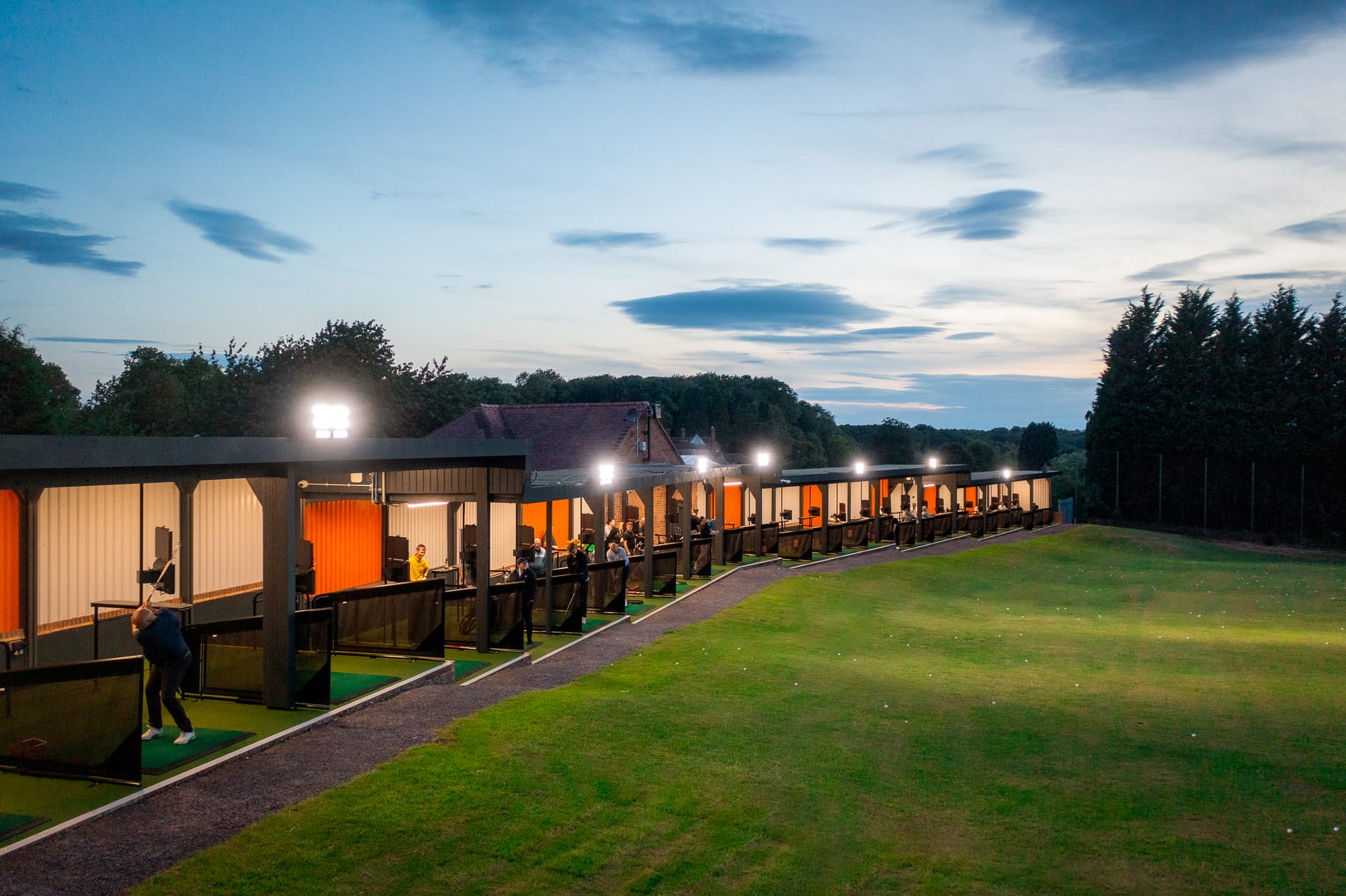 TrackMan driving range Shropshire illuminated at night, offering virtual golf and family golf range experiences at The Shropshire