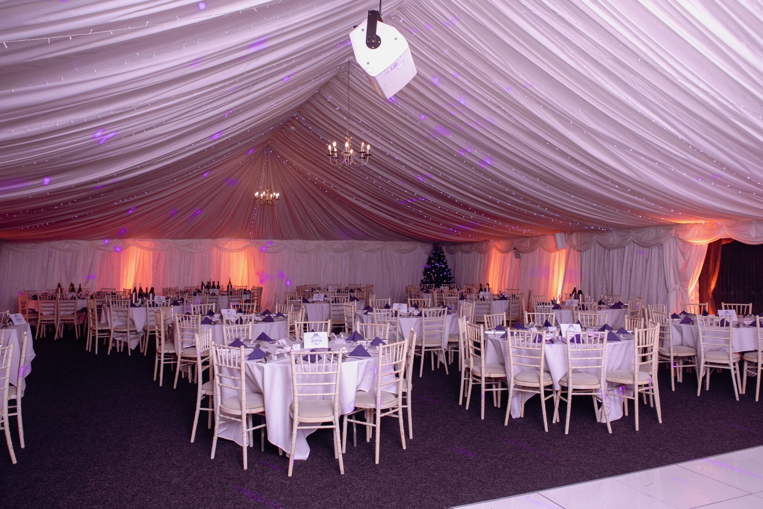 Marquee setup with ambient lighting and decorated tables, ideal for celebrations and private hire at party venues in Telford