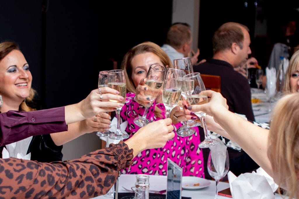 Guests chinking glasses at a lively party venue in Shropshire, celebrating an event at The Shropshire Golf and Country Club